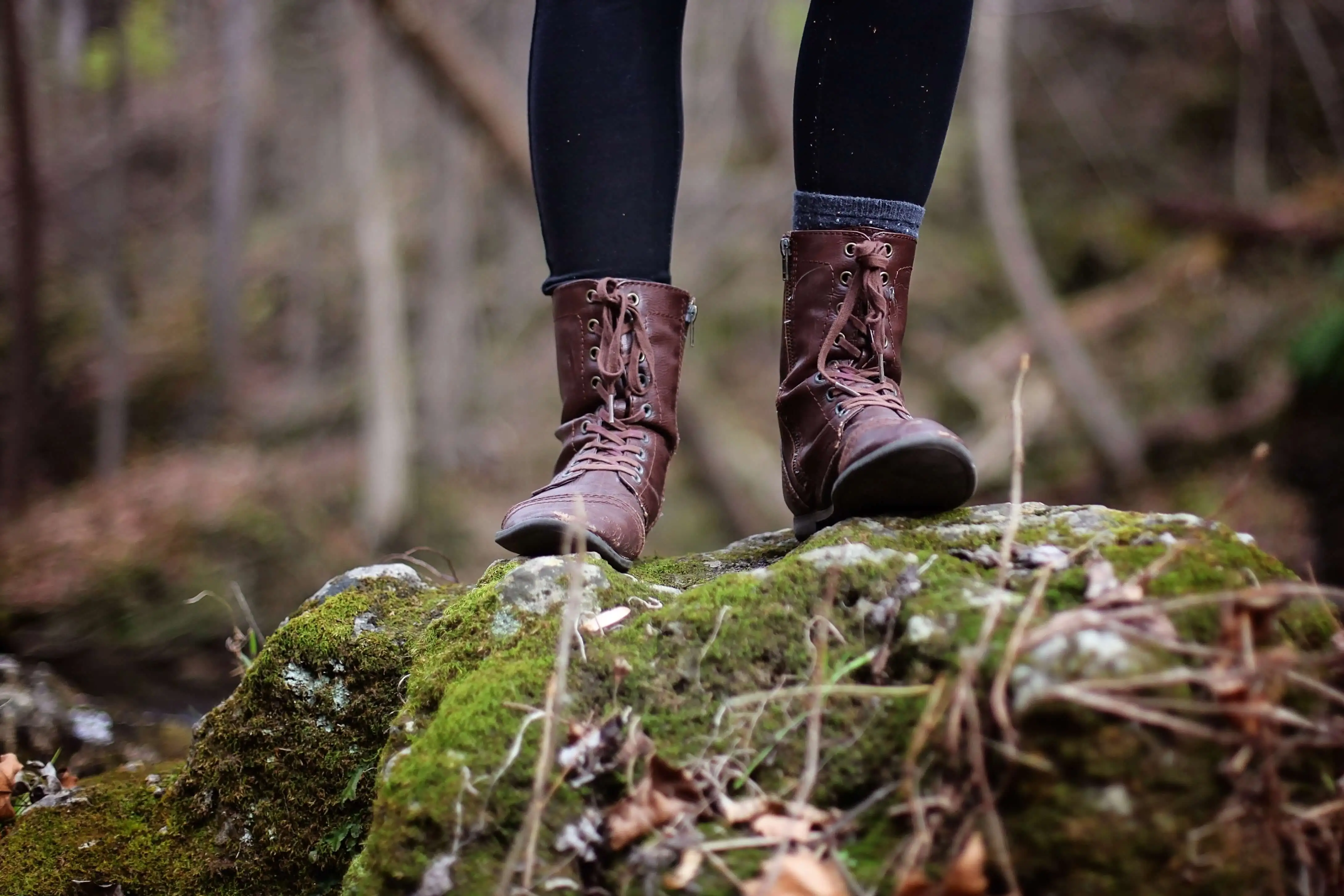 Woman standing on forest floor